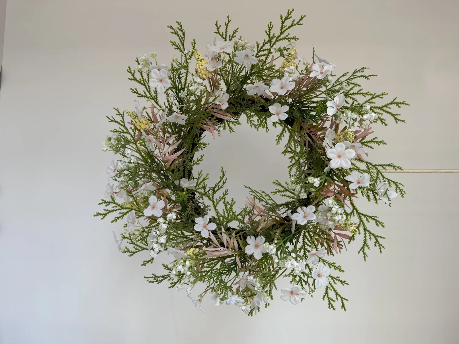 White floral and cedar artificial wreath